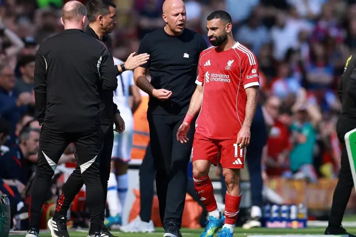 Mohamed Salah walking off the pitch with staff Mohamed Salah walking off the pitch with staff