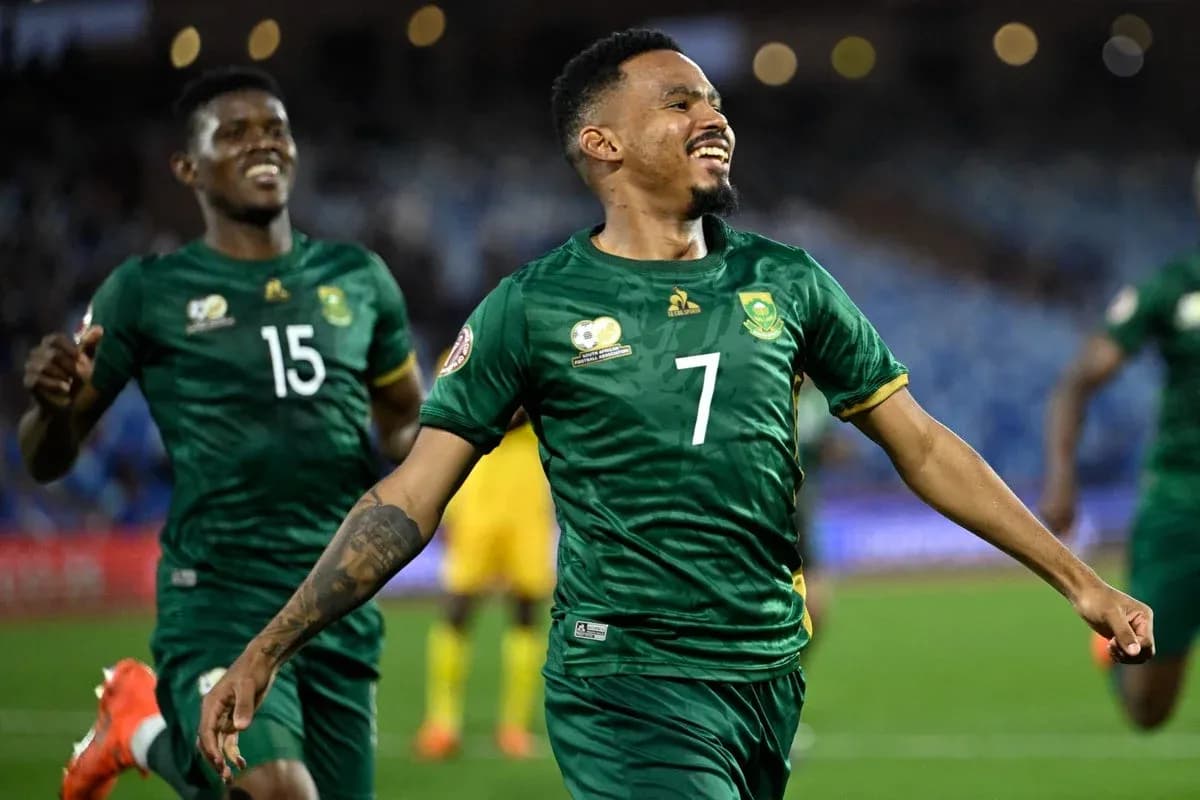Player celebrating a goal with teammates in match Player celebrating a goal with teammates in match