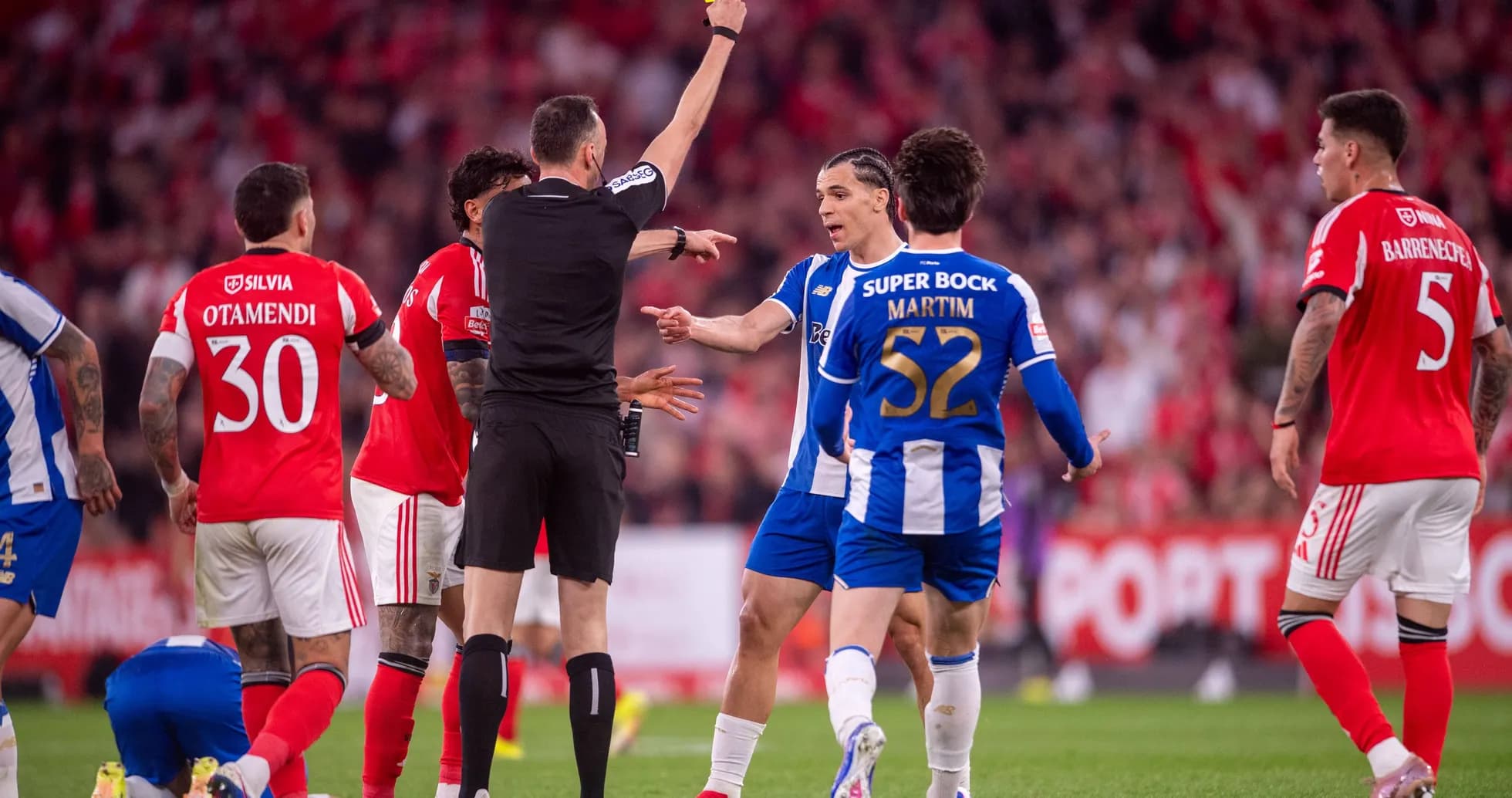 Referee showing yellow card to player during match Referee showing yellow card to player during match