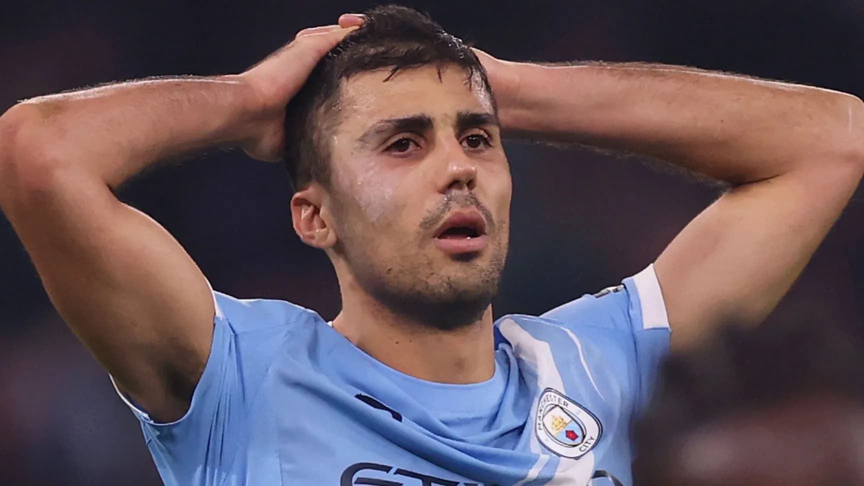 Player holding head in disappointment on field Player holding head in disappointment on field