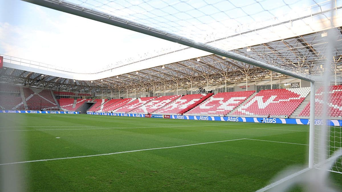 View of empty stadium with goalpost and grass pitch View of empty stadium with goalpost and grass pitch