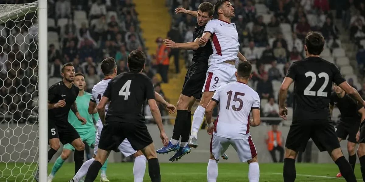 Players jumping for a header in a match Players jumping for a header in a match