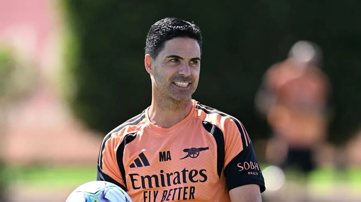 Arsenal manager holding a ball during training session Arsenal manager holding a ball during training session