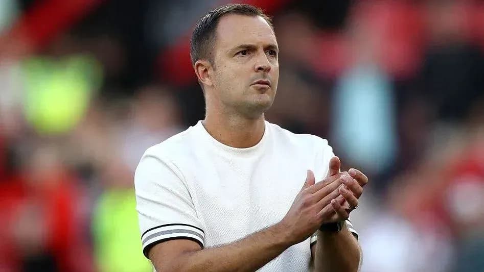 Coach applauding during a match on the sidelines Coach applauding during a match on the sidelines