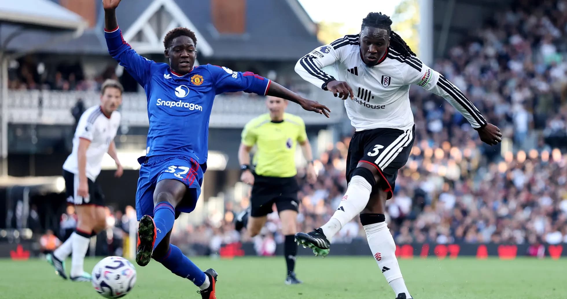 Fulham player competing against Manchester United opponent Fulham player competing against Manchester United opponent