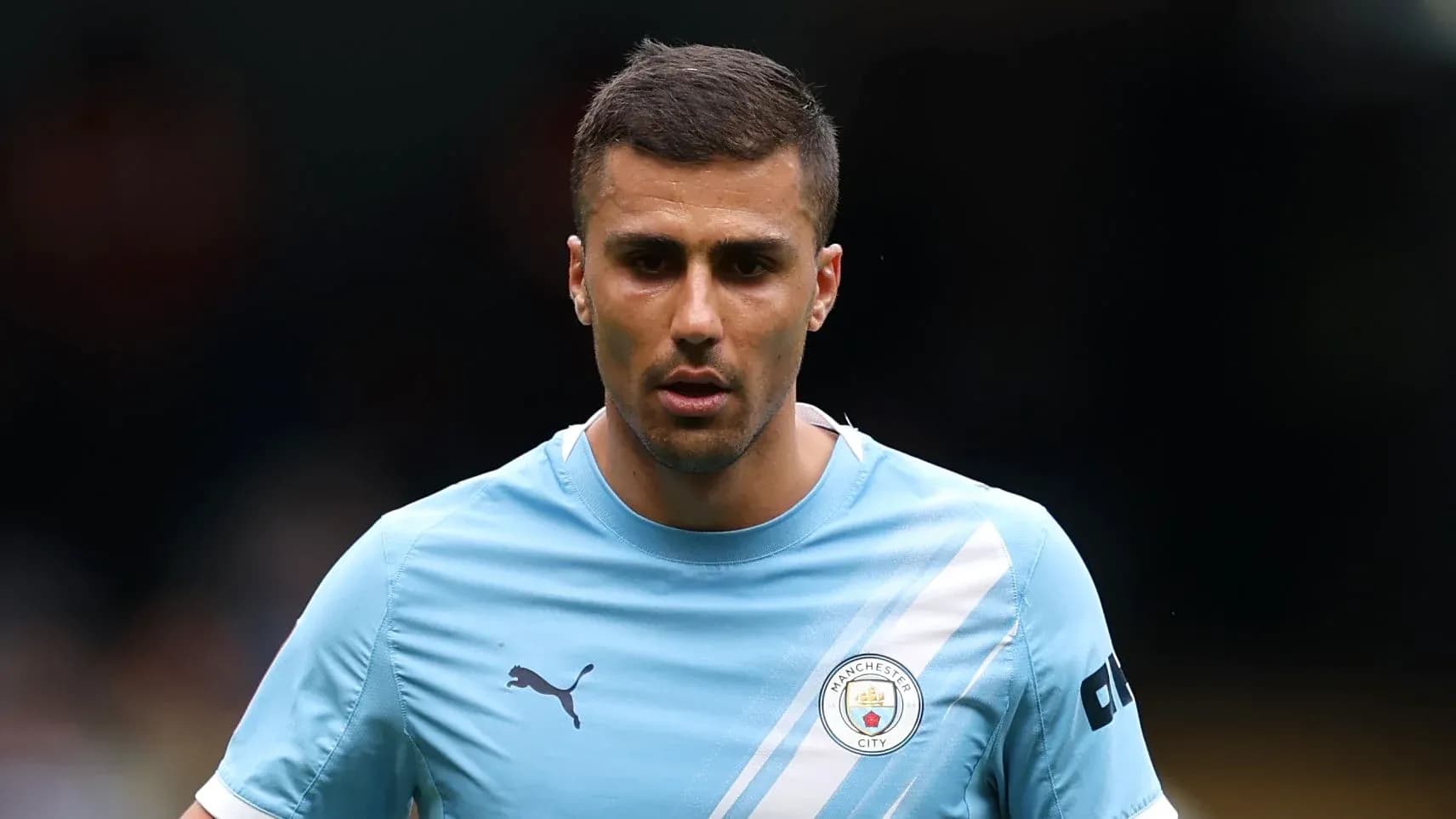 Player in Manchester City training kit on field Player in Manchester City training kit on field