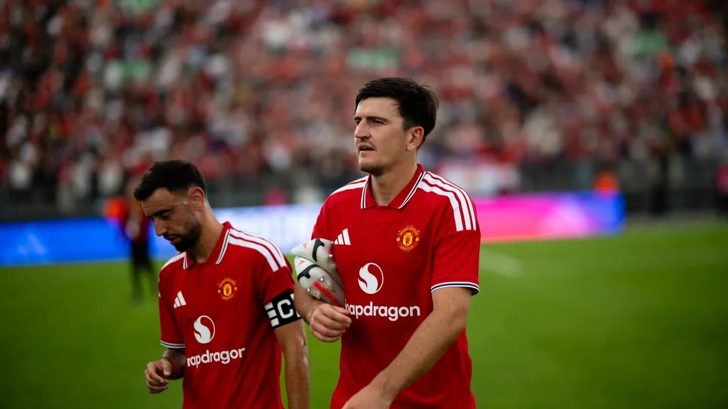 Two Manchester United players walking off the pitch Two Manchester United players walking off the pitch