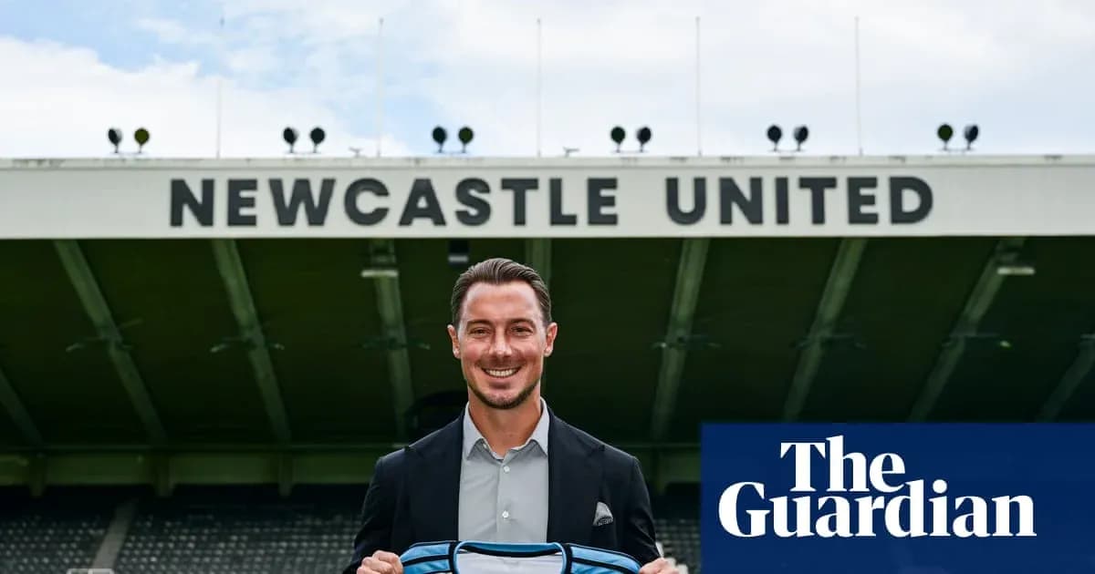 Player holding Newcastle United shirt at stadium Player holding Newcastle United shirt at stadium