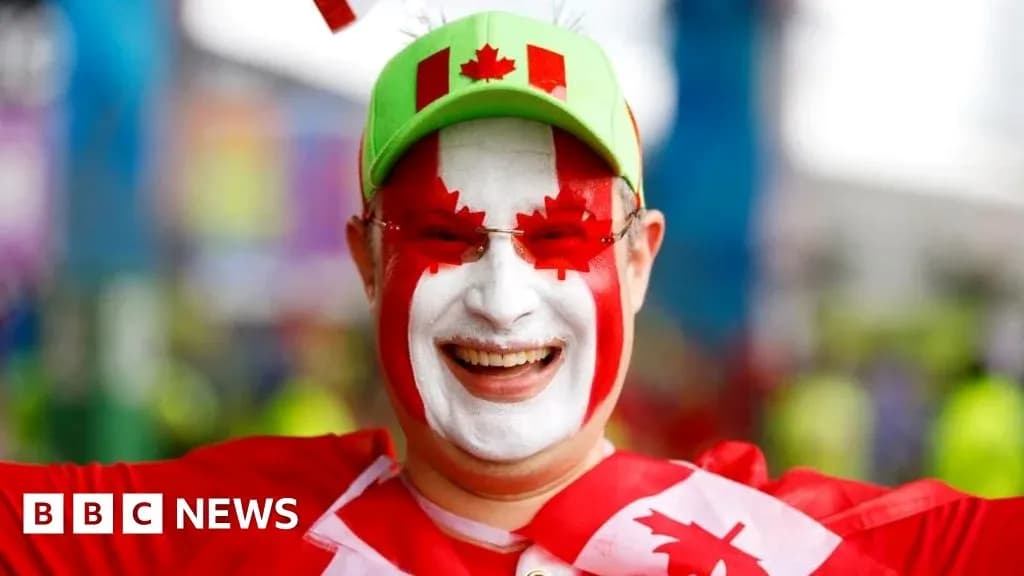 Fan wearing Canadian colors and face paint smiling Fan wearing Canadian colors and face paint smiling