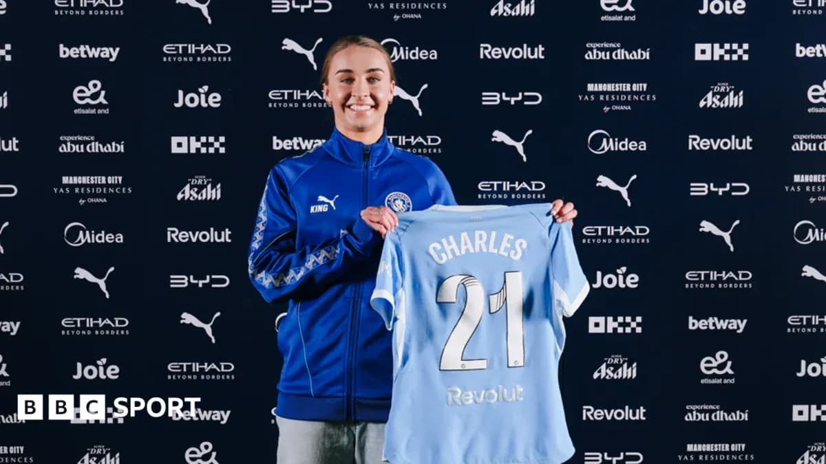 Player holding Manchester City jersey at announcement Player holding Manchester City jersey at announcement