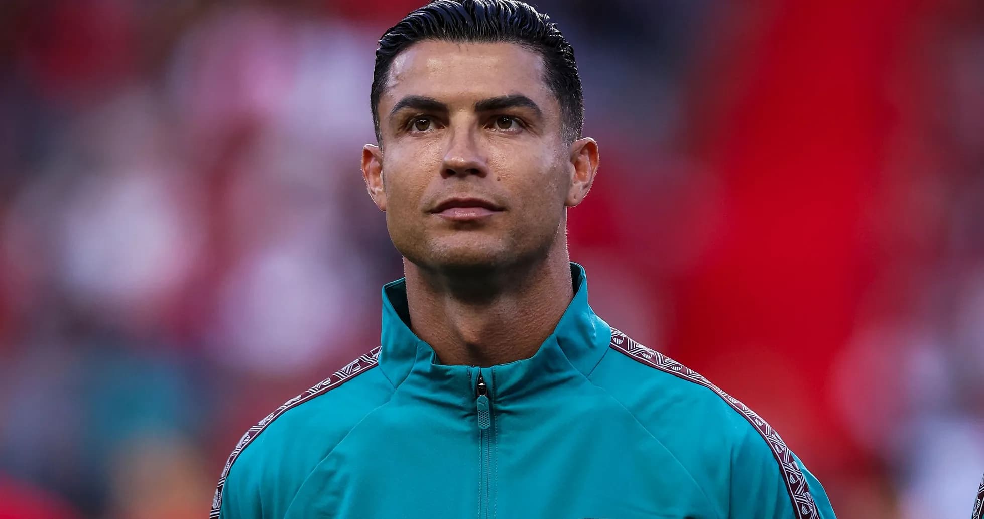 Player wearing teal jacket during match warm-up Player wearing teal jacket during match warm-up