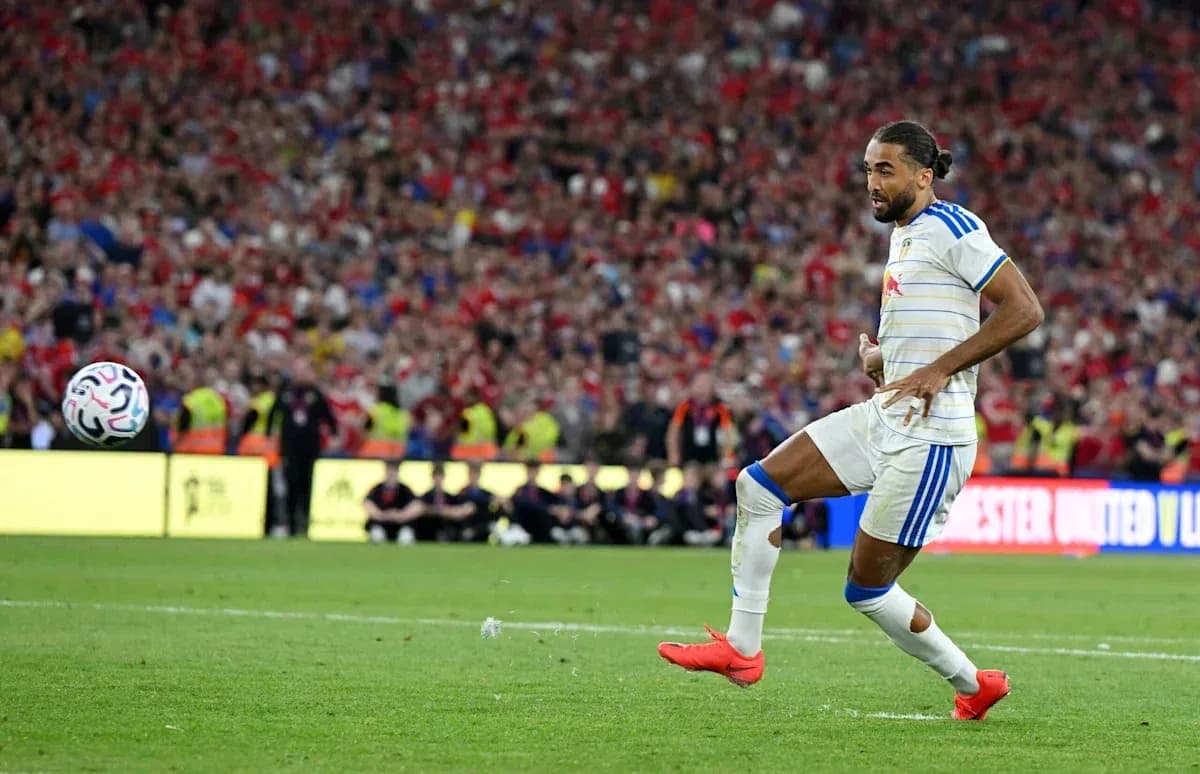 Player kicking a soccer ball during a match Player kicking a soccer ball during a match