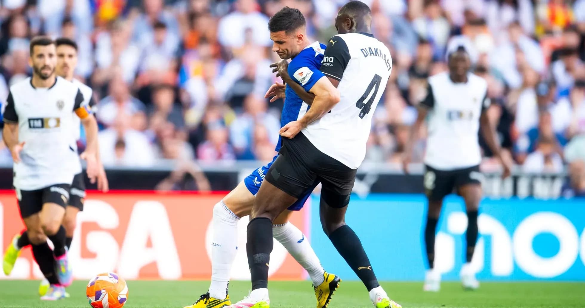 Players competing for the ball during La Liga match Players competing for the ball during La Liga match
