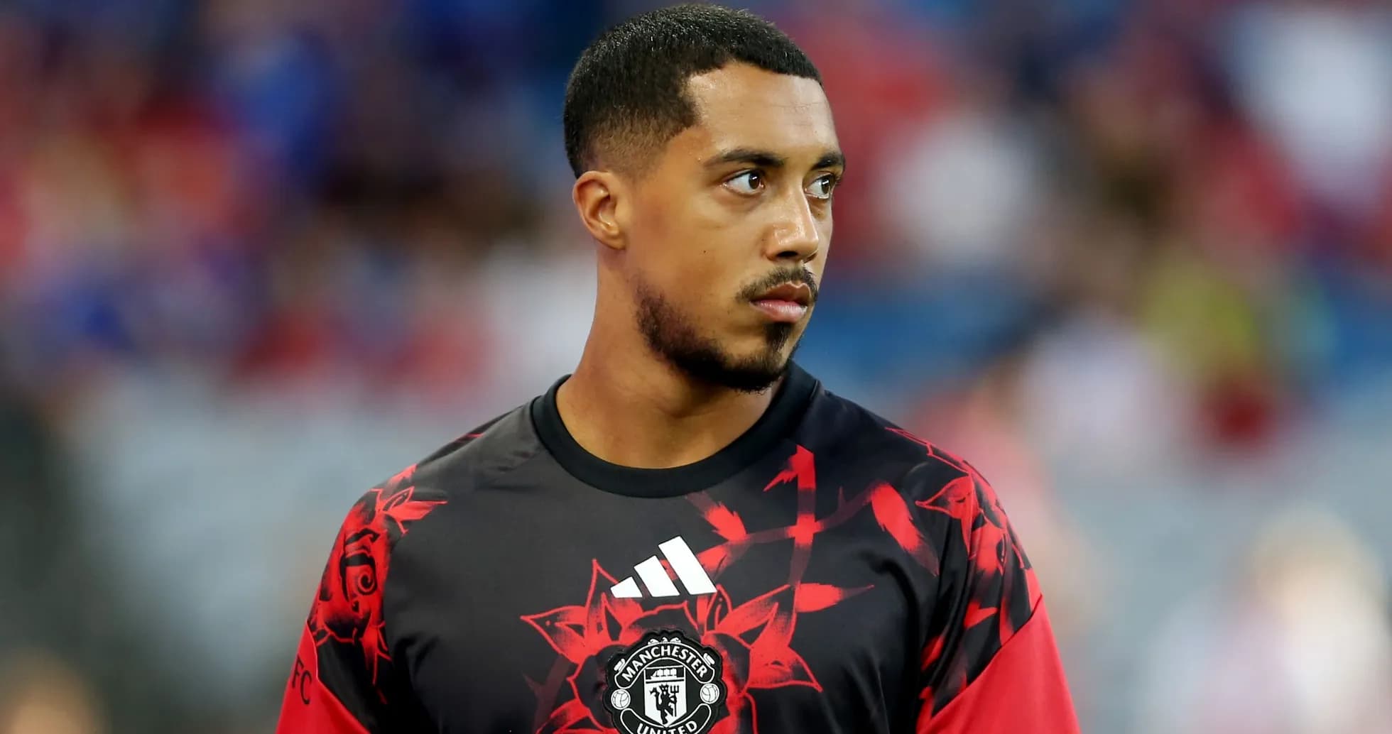 Player in Manchester United training kit on field Player in Manchester United training kit on field