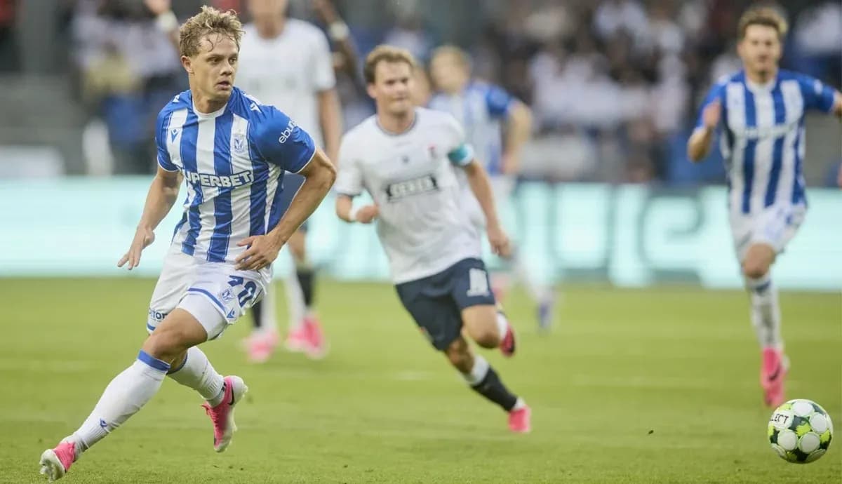 Lech Poznan player dribbling past Aarhus defenders Lech Poznan player dribbling past Aarhus defenders