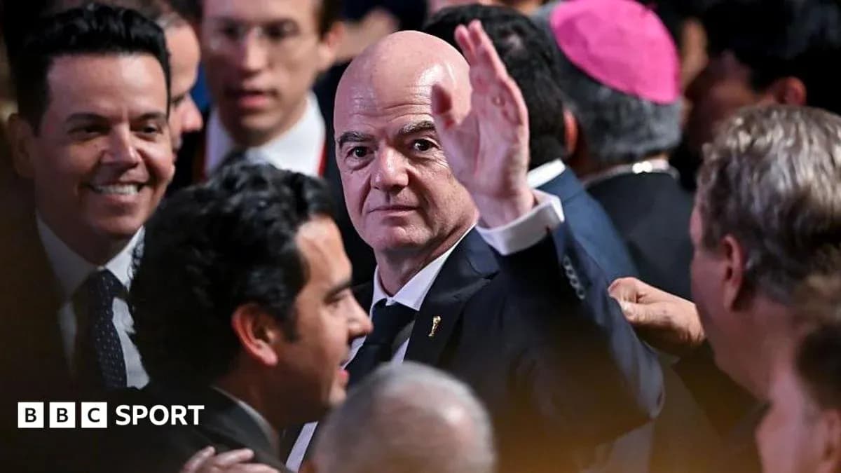 Gianni Infantino waving at an event surrounded by people Gianni Infantino waving at an event surrounded by people