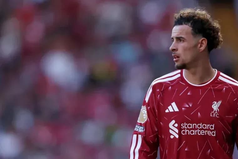 Player wearing Liverpool jersey on the pitch Player wearing Liverpool jersey on the pitch