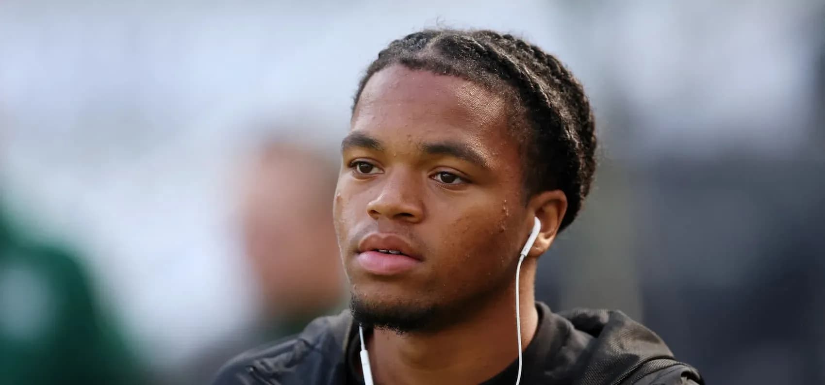 Player wearing earbuds, focused before the match Player wearing earbuds, focused before the match