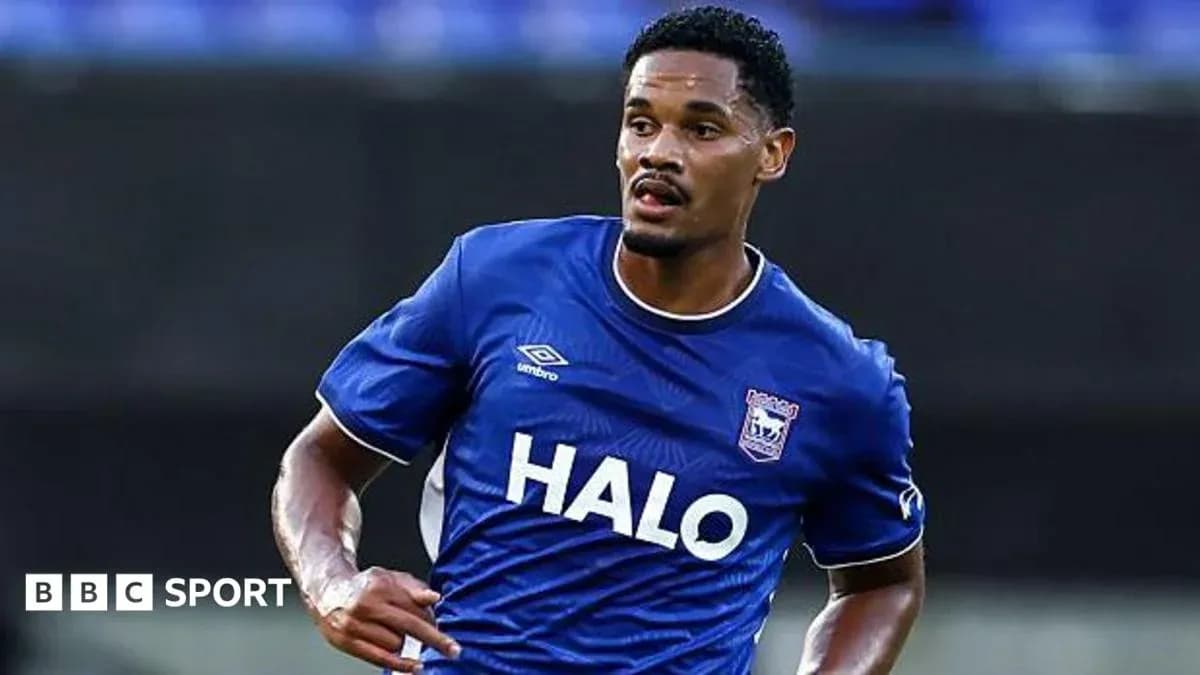 Player in blue kit running on the field Player in blue kit running on the field