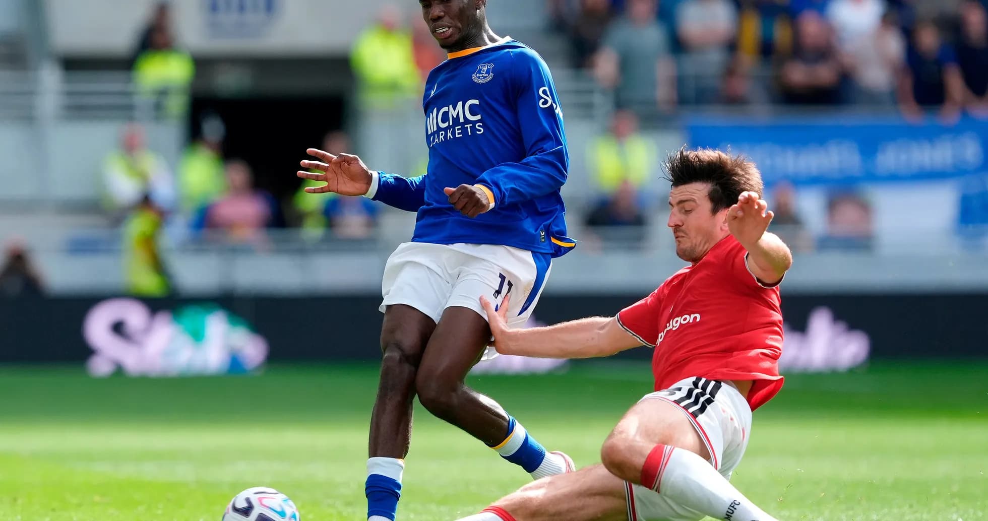 Everton player tackling Manchester United opponent Everton player tackling Manchester United opponent