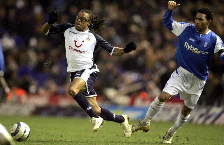 Player evading a tackle during a football match Player evading a tackle during a football match