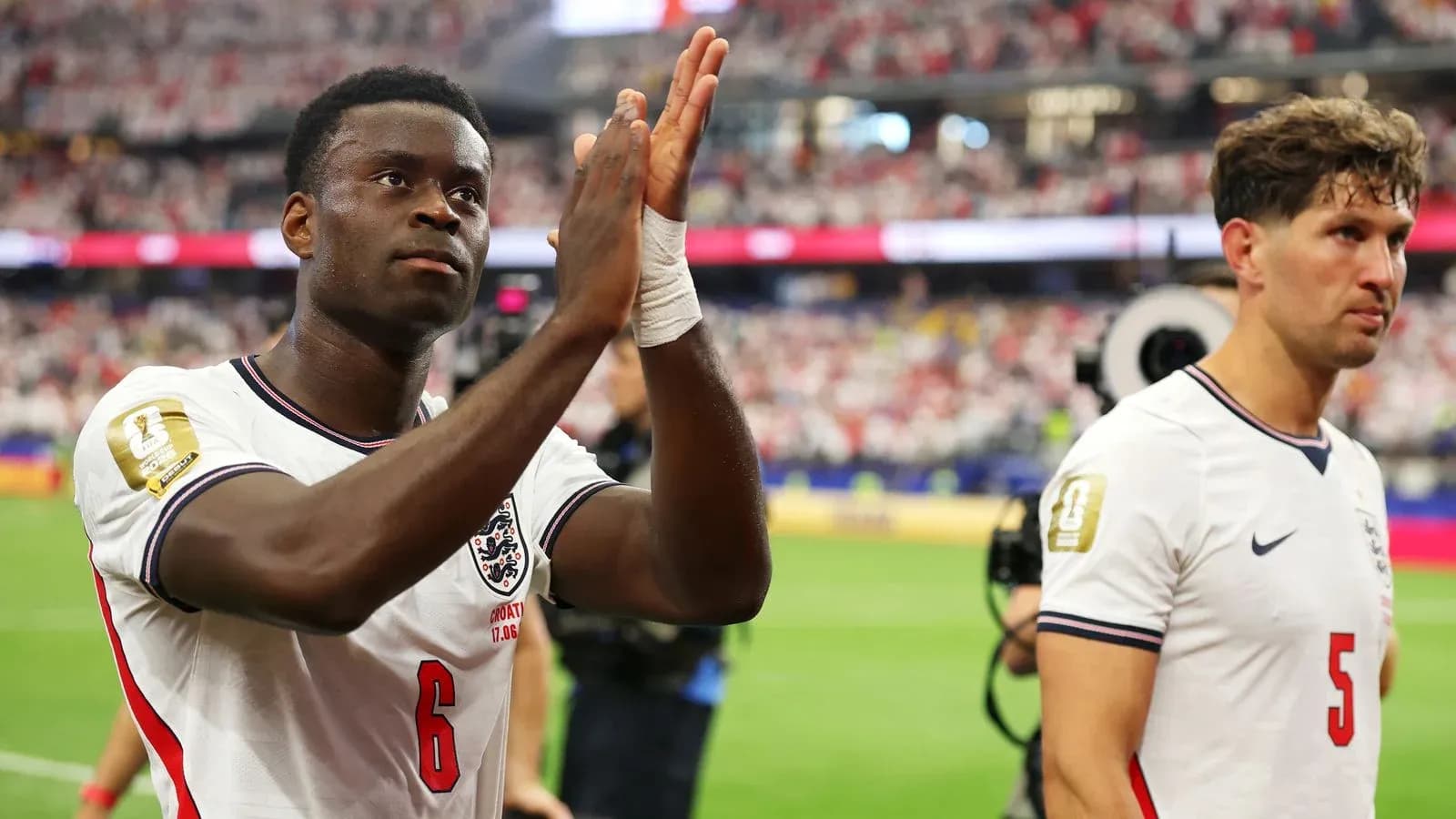 Two England players applauding fans after match Two England players applauding fans after match