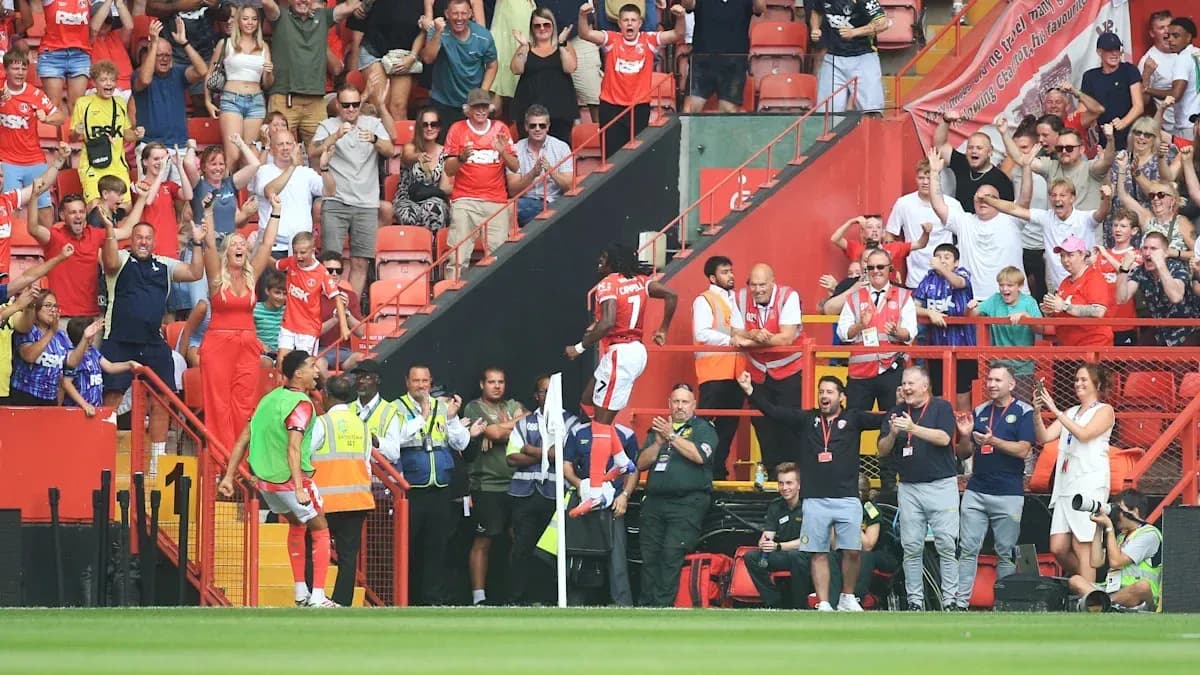 Fans celebrating as player scores goal near corner flag Fans celebrating as player scores goal near corner flag