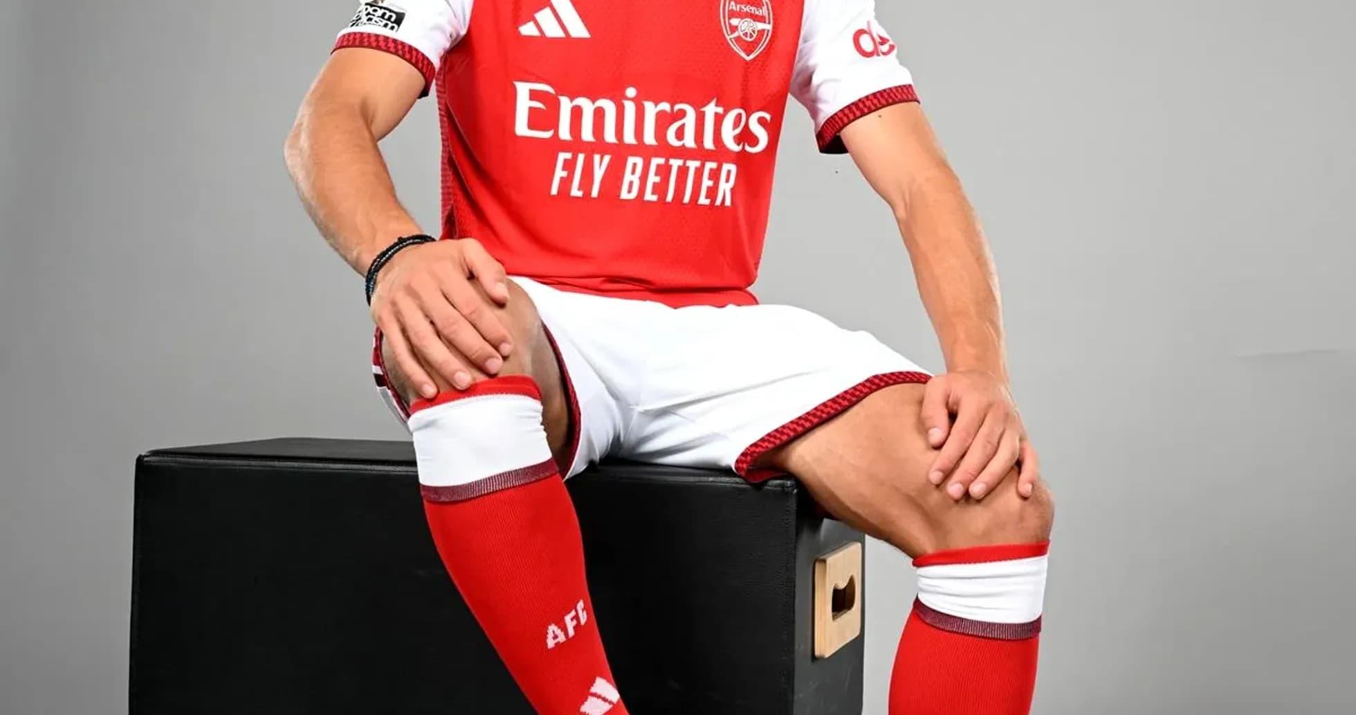 Player in Arsenal kit sitting on a box Player in Arsenal kit sitting on a box