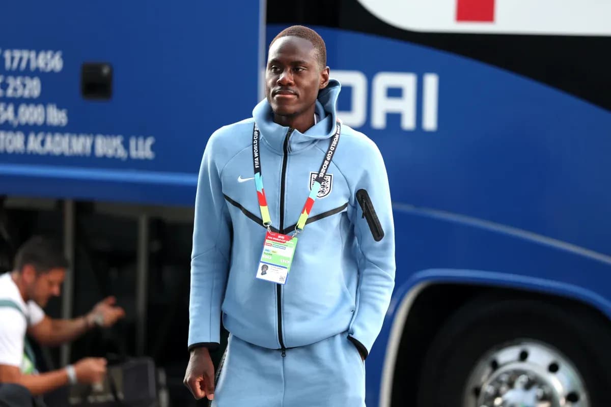 Player wearing team tracksuit near team bus Player wearing team tracksuit near team bus