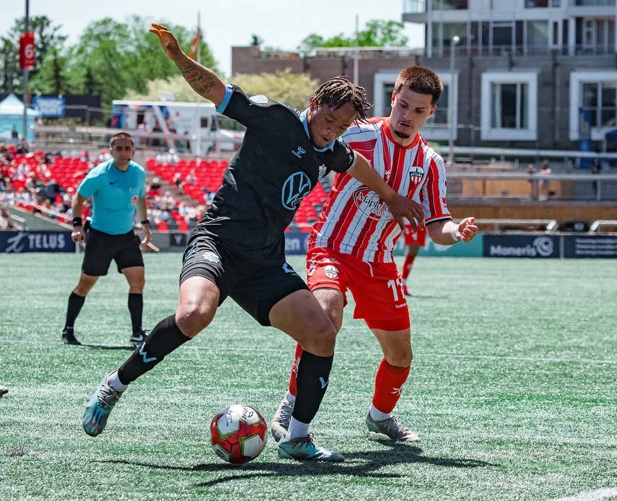Player challenging for the ball during match Player challenging for the ball during match