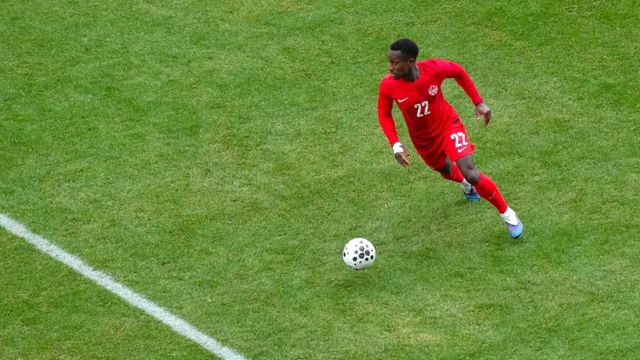 Player in red jersey chasing the ball Player in red jersey chasing the ball