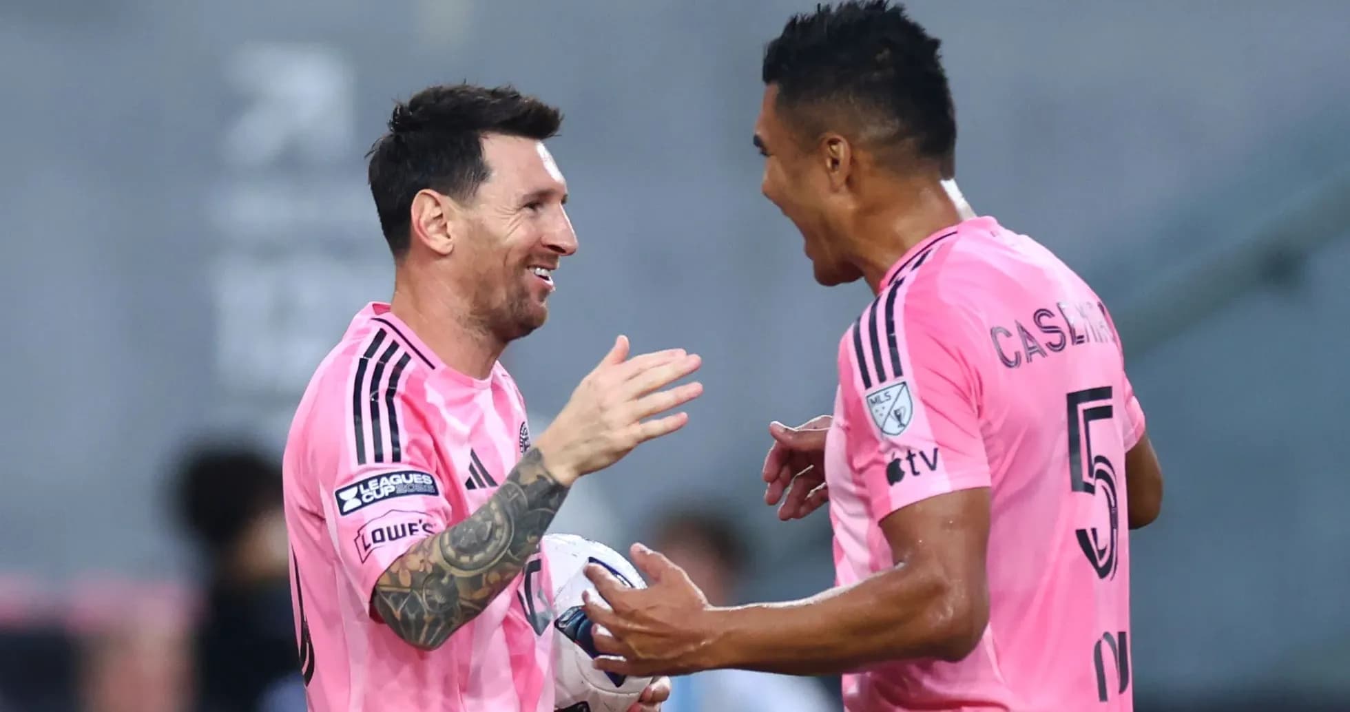 Players celebrating during a match in pink uniforms Players celebrating during a match in pink uniforms