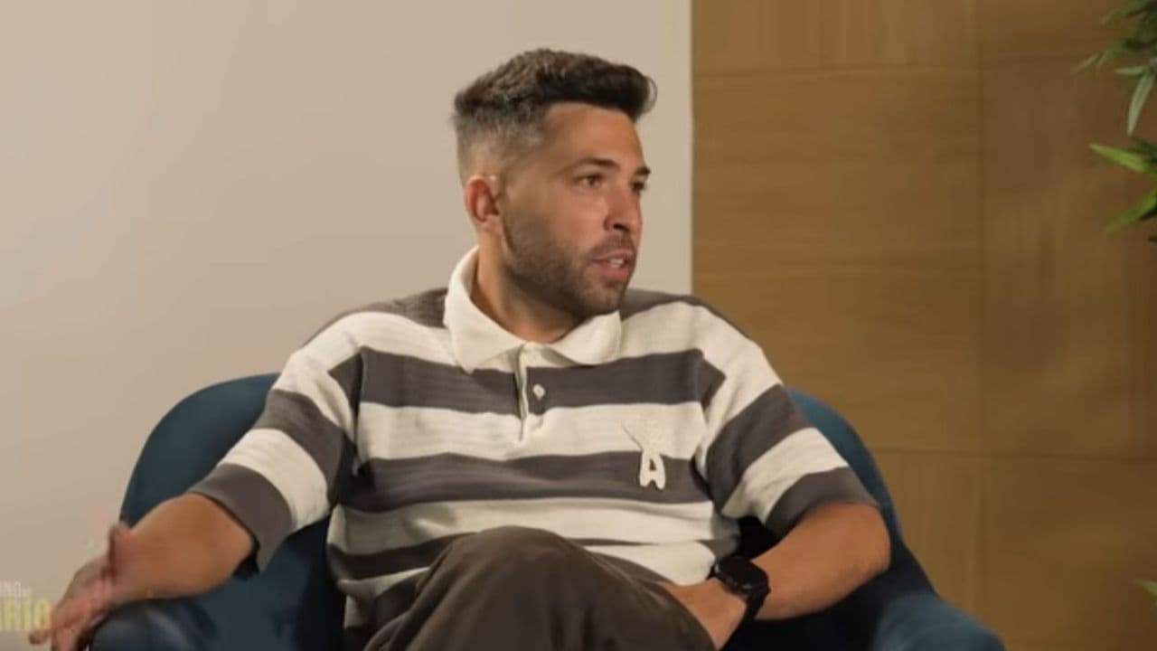 Person speaking during an interview on a couch Person speaking during an interview on a couch