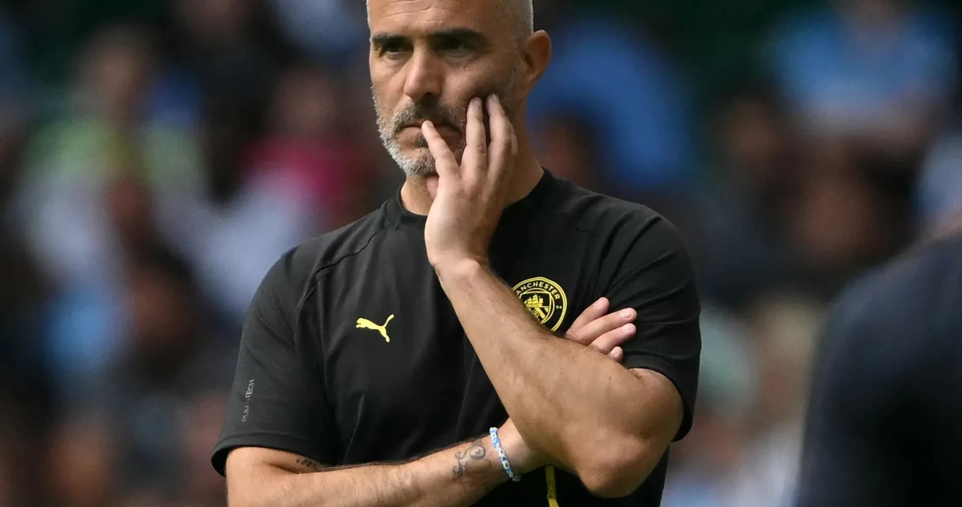 Manager observing the match with a thoughtful expression Manager observing the match with a thoughtful expression