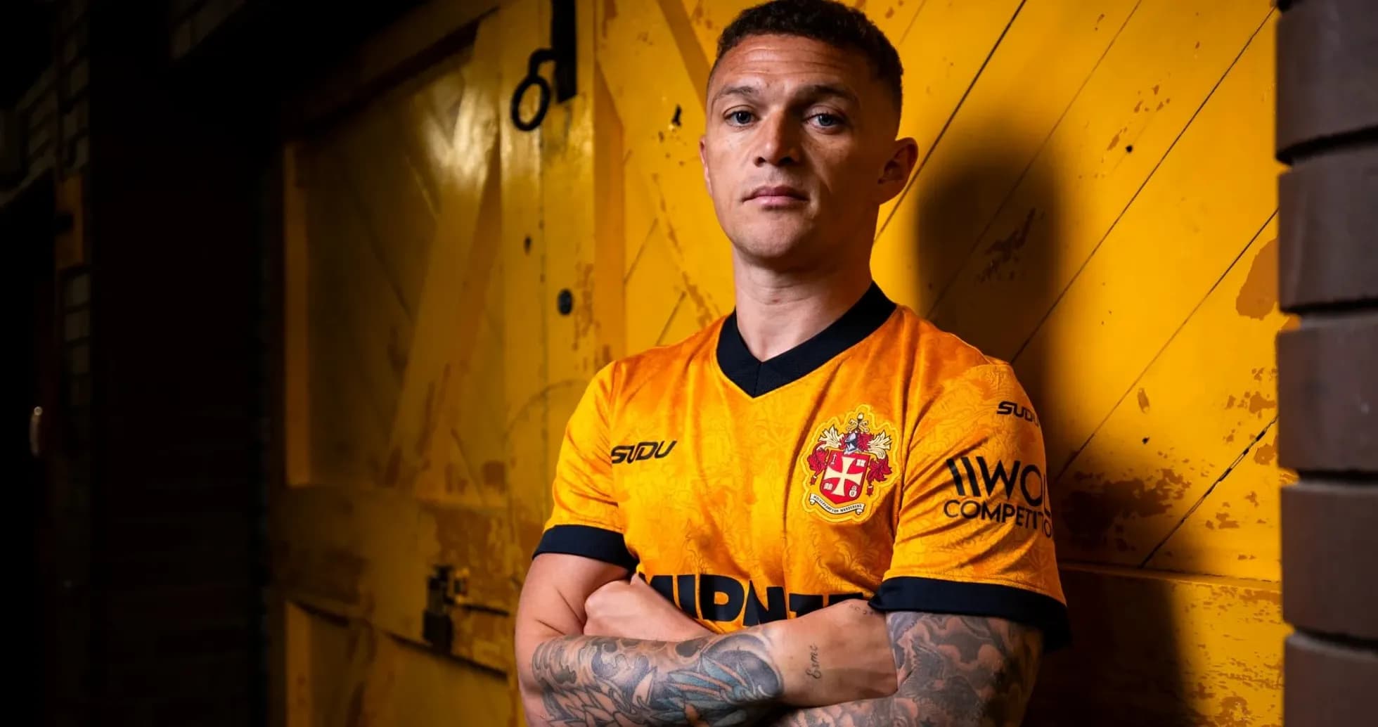 Player posing in orange team jersey against yellow background Player posing in orange team jersey against yellow background