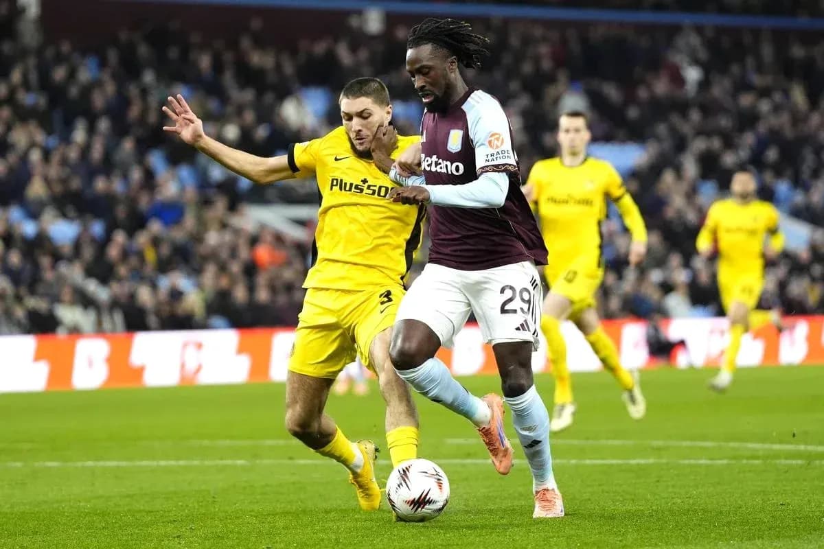 Player dribbling the ball under defensive pressure Player dribbling the ball under defensive pressure