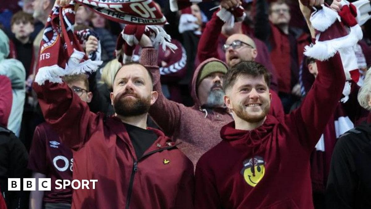Fans cheering with scarves in stadium crowd Fans cheering with scarves in stadium crowd