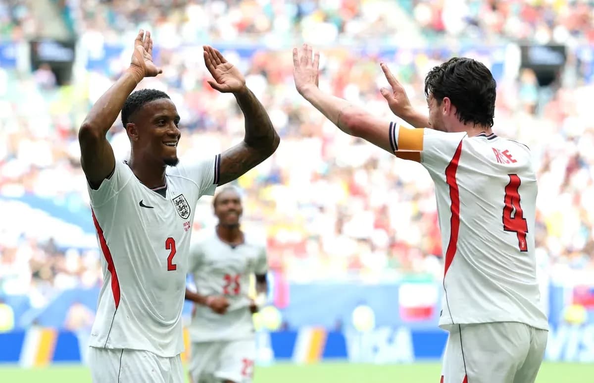 Two England players celebrating a goal on field Two England players celebrating a goal on field