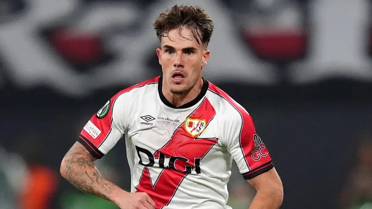 Player in Rayo Vallecano jersey running on field Player in Rayo Vallecano jersey running on field