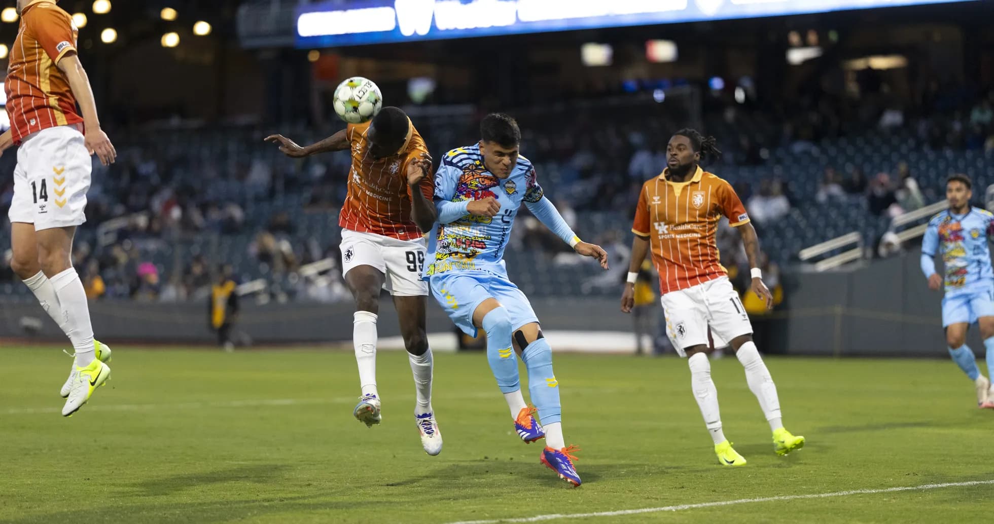 Players contesting a header during USL Championship match Players contesting a header during USL Championship match