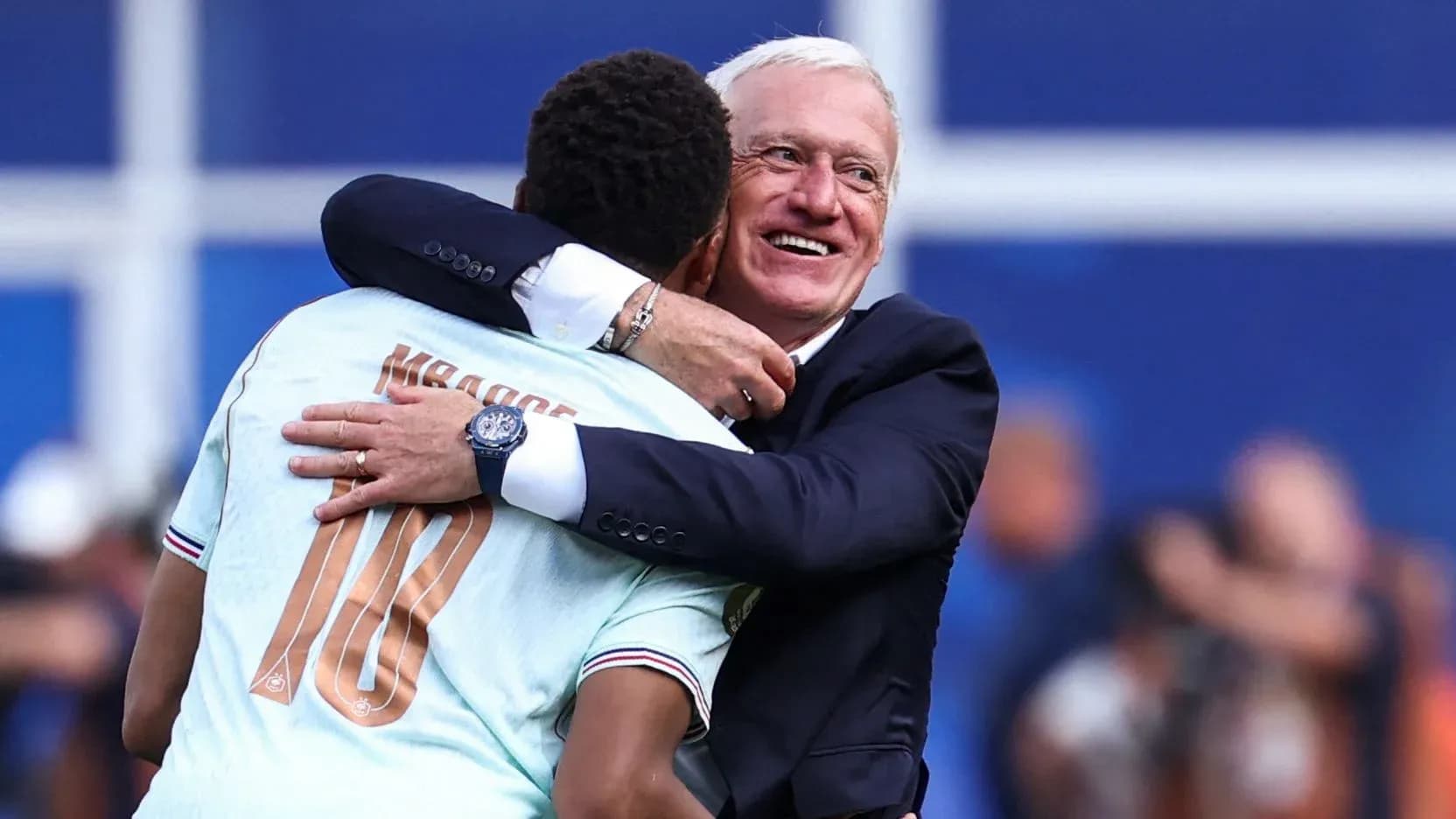 Player and coach celebrating with a hug Player and coach celebrating with a hug