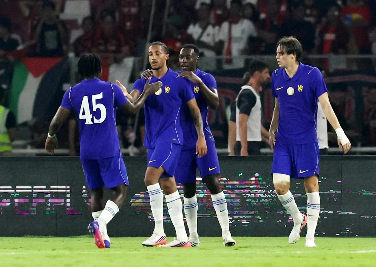 Four players celebrating a goal in purple jerseys Four players celebrating a goal in purple jerseys