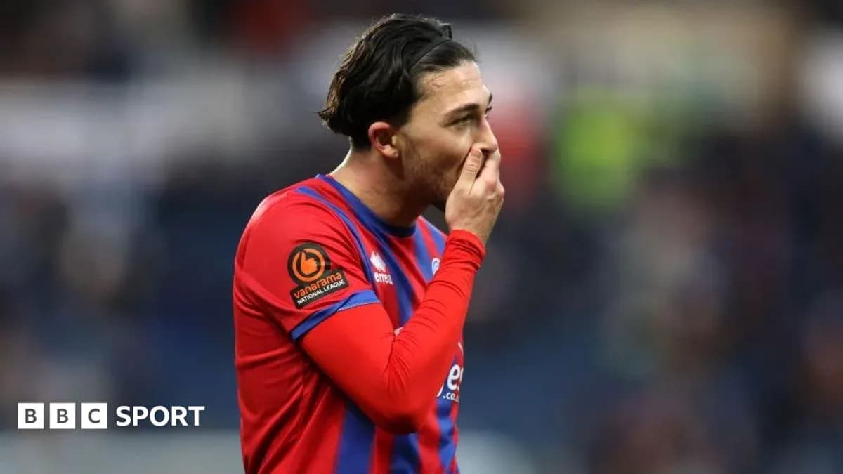 Player in red jersey showing concern during match Player in red jersey showing concern during match