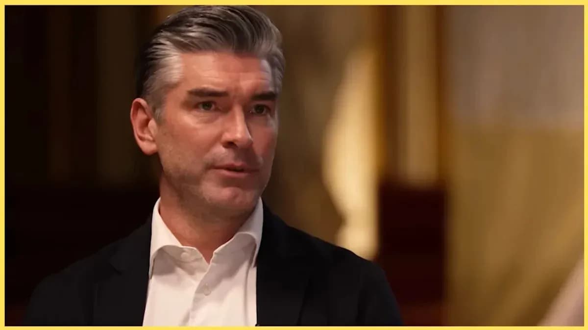 Man speaking during an interview in a formal setting Man speaking during an interview in a formal setting