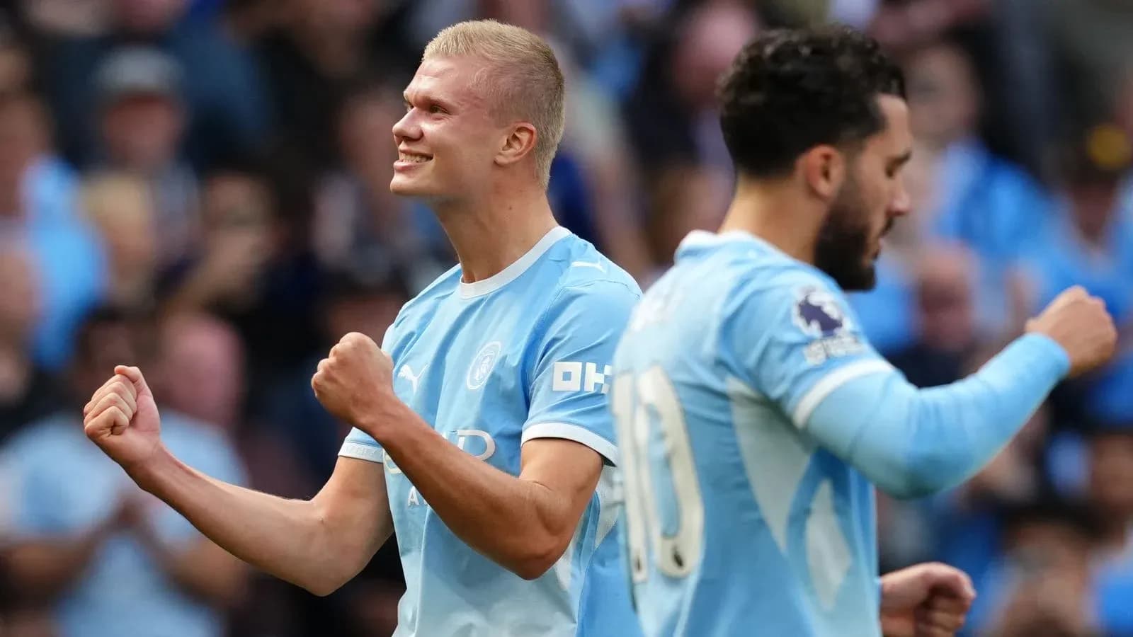 Player celebrating a goal with teammate in stadium Player celebrating a goal with teammate in stadium