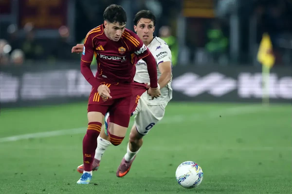 Player sprinting with ball, opponent chasing during match Player sprinting with ball, opponent chasing during match