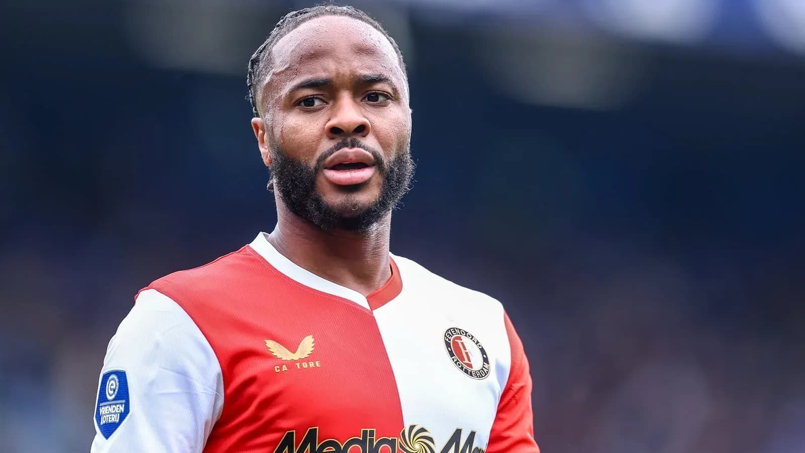 Feyenoord player in red and white jersey on field Feyenoord player in red and white jersey on field