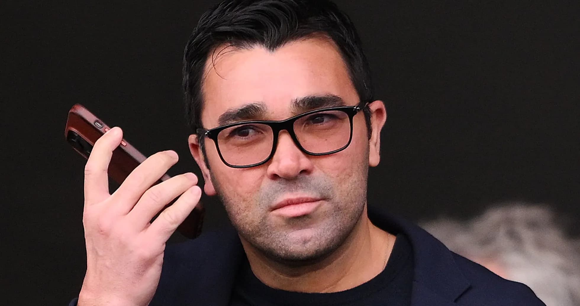 Man holding a phone while looking intently Man holding a phone while looking intently