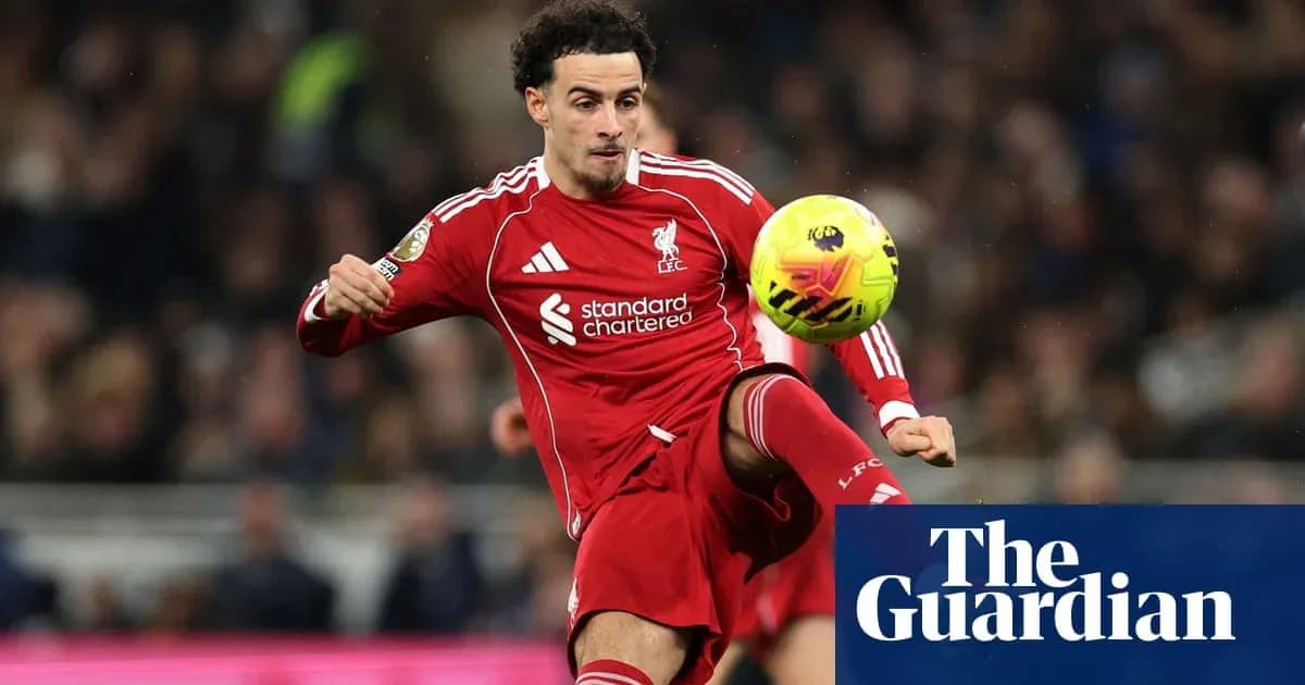Liverpool player kicking ball during match action Liverpool player kicking ball during match action