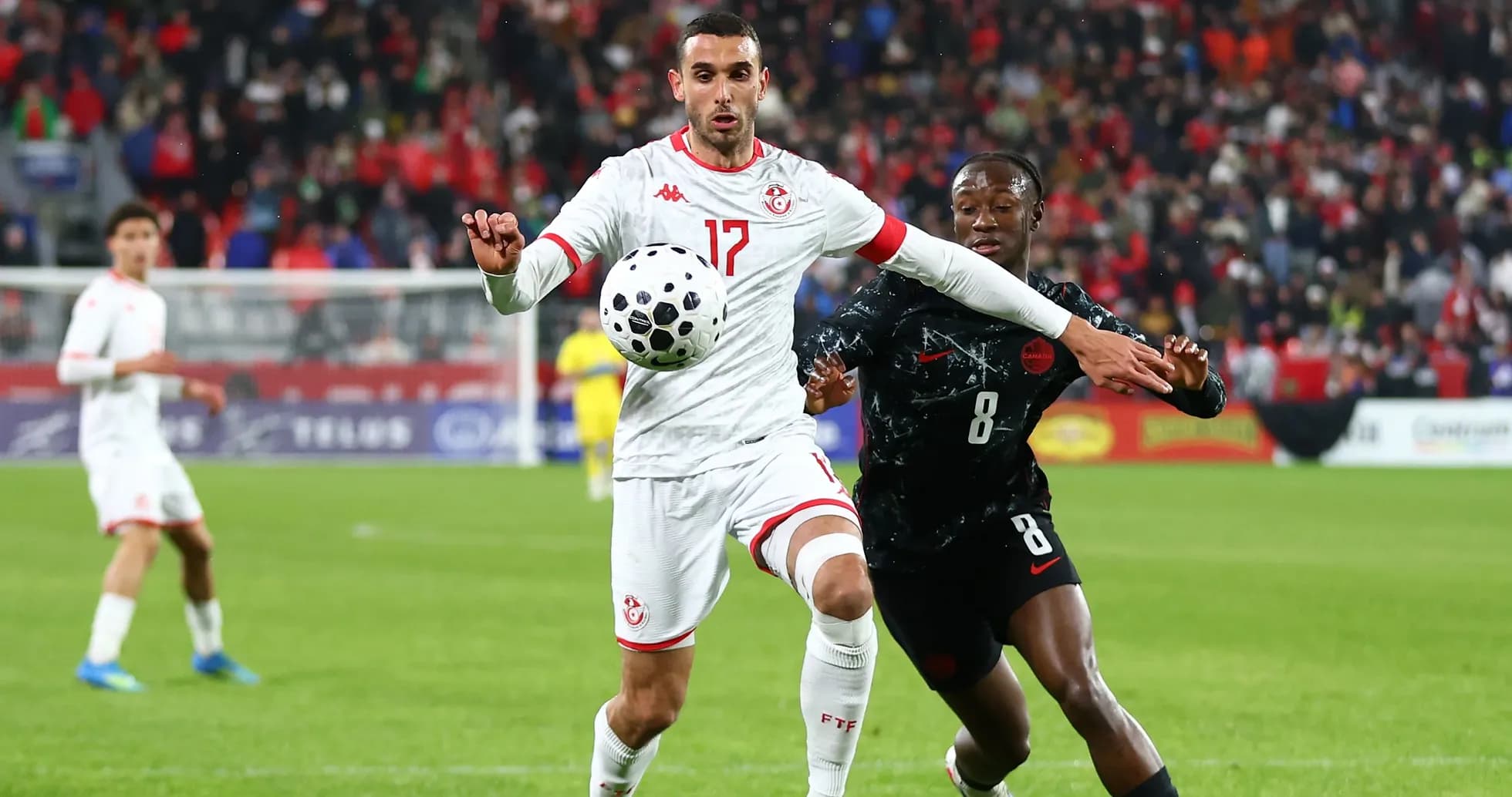 Players contesting for the ball during a match Players contesting for the ball during a match